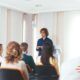 A person delivers an informative presentation to a group, fostering a collaborative learning atmosphere.