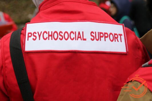 Individual wearing a red jacket with 