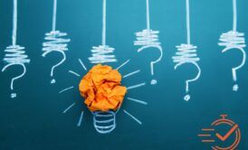 a light bulb with question marks and crumpled paper, illustrating the concepts of analytical thinking vs critical thinking