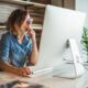 a woman in glasses works at her desk, engaged with her computer, during a 2d whiteboard animation for beginners class