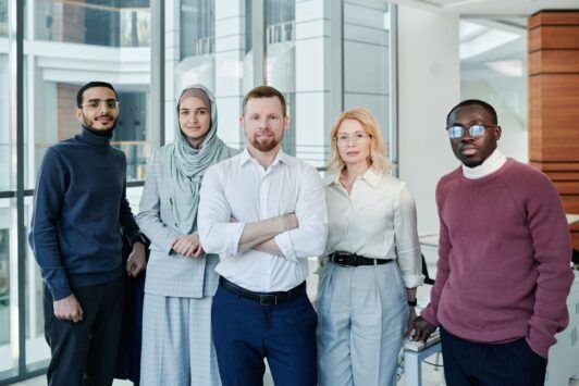 a group of young individuals exuding confidence, standing in an office, representing confidence in work