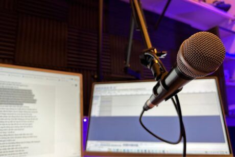 A microphone and computer screen displaying 'Notion for Beginners' course notes