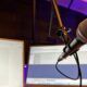 A microphone and computer screen displaying 'Notion for Beginners' course notes