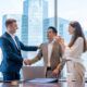 two business individuals shaking hands in an office, illustrating the art of persuasion in professional relationships
