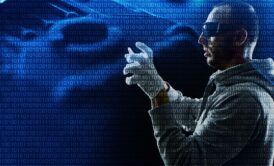 A man in a hoodie and gloves stands confidently, embodying the basics of ethical hacking.