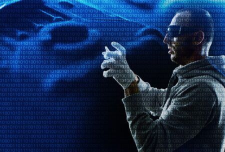 A man in a hoodie and gloves stands confidently, embodying the basics of ethical hacking.