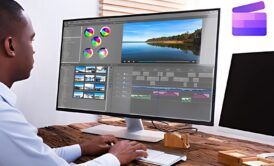 A man working on video editing tasks using Clipchamp software on his laptop.