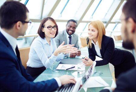 business professionals engaged in an effective meeting around a conference table in a modern office setting