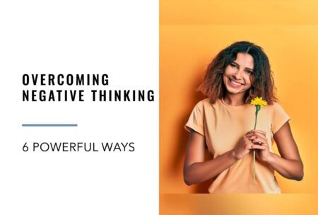 a woman smiling while holding a flower, symbolizing how to overcome negative thinking
