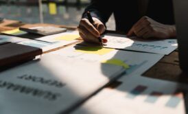 Businessman engaged in creating a business plan, with a focus on achieving product owner certification scrum exam for career advancement.