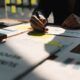 Businessman engaged in creating a business plan, with a focus on achieving product owner certification scrum exam for career advancement.