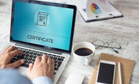A man taking his Professional Scrum Master Certification exam on a laptop.