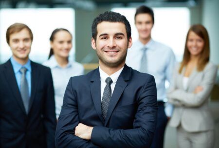 businessman confidently addressing his team, sharing insights on self-confidence secrets for professional growth
