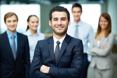 businessman confidently addressing his team, sharing insights on self-confidence secrets for professional growth
