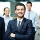 businessman confidently addressing his team, sharing insights on self-confidence secrets for professional growth