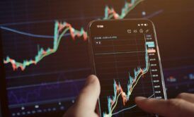 mobile phone displaying stock market trading, highlighting stock investments courses for potential investors