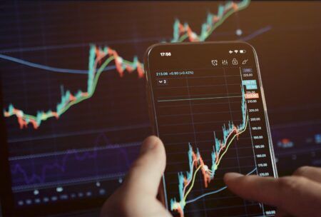 mobile phone displaying stock market trading, highlighting stock investments courses for potential investors