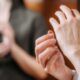 a woman places one hand against the other, illustrating a concept from eft training