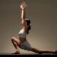 a woman in a white top is engaged in a yoga pose for her hatha yoga online training class