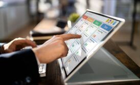 an individual uses a touch screen laptop to explore an introduction to agile concepts