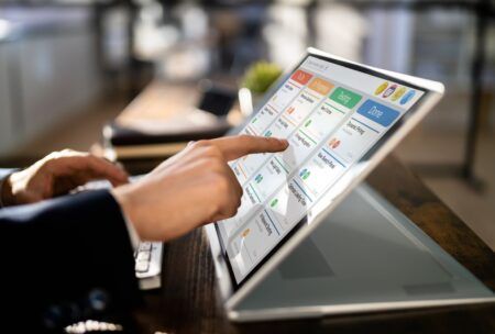 an individual uses a touch screen laptop to explore an introduction to agile concepts