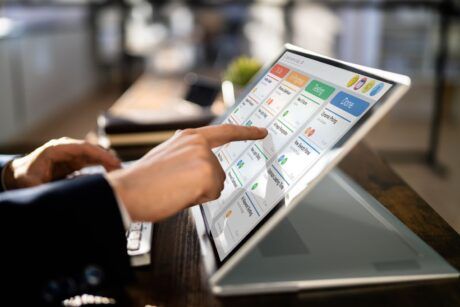 an individual uses a touch screen laptop to explore an introduction to agile concepts