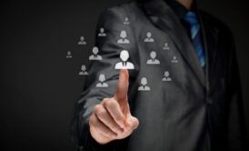 businessman pointing to icons of diverse people, illustrating effective HR practices in a corporate setting