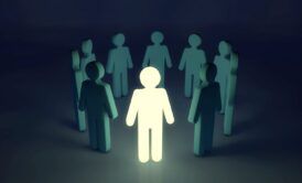 a person stands confidently in a circle of people, embodying an innovative mindset and fostering collaboration