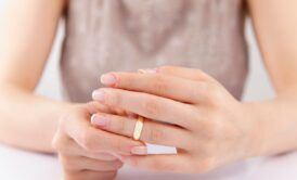 a divorce coach displays a gold ring on her hand, representing a pivotal moment in her journey or client interactions