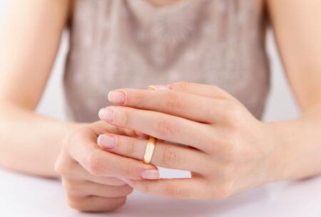 a divorce coach displays a gold ring on her hand, representing a pivotal moment in her journey or client interactions