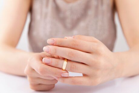 a divorce coach displays a gold ring on her hand, representing a pivotal moment in her journey or client interactions