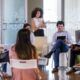 a group of people seated in chairs during a facilitation course in a meeting room